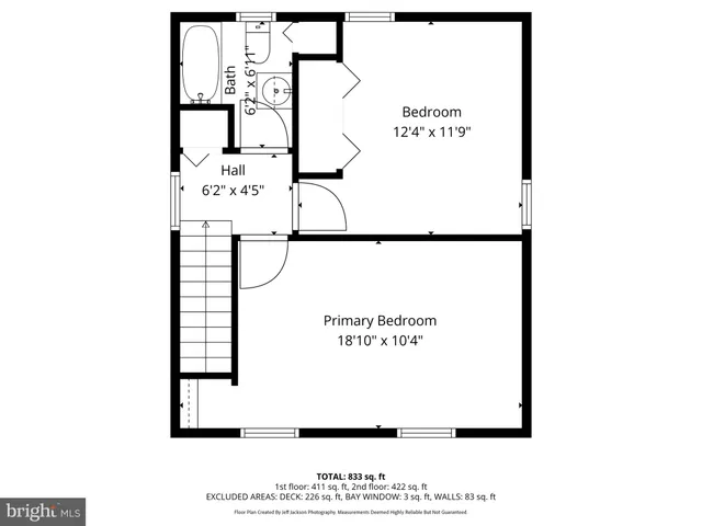 a view of a backyard with plants and wooden fence