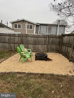 a swimming pool with outdoor seating and yard