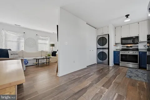 a living room with furniture and a fireplace with wooden floor
