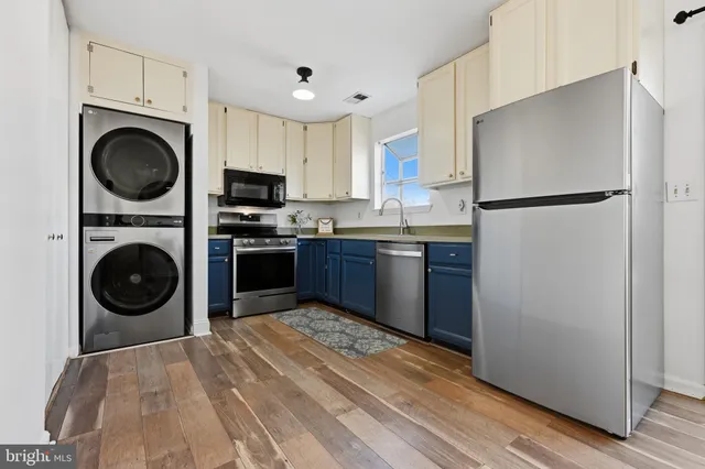 a kitchen with a stove top oven and refrigerator