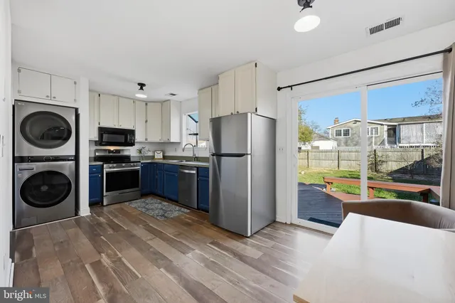 a kitchen with stainless steel appliances granite countertop a refrigerator and a sink