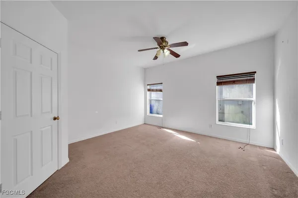 a view of a dining room with furniture and chandelier fan