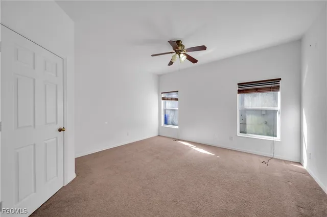 a view of a dining room with furniture and chandelier fan