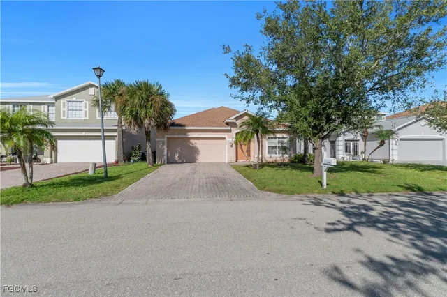 a front view of a house with a yard and a garage