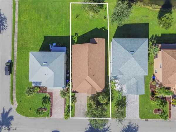an aerial view of a house with a garden and lake view