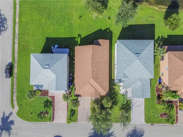 an aerial view of a house with a garden and lake view