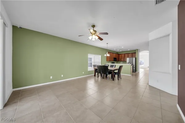 a view of a dining room with furniture and chandelier fan