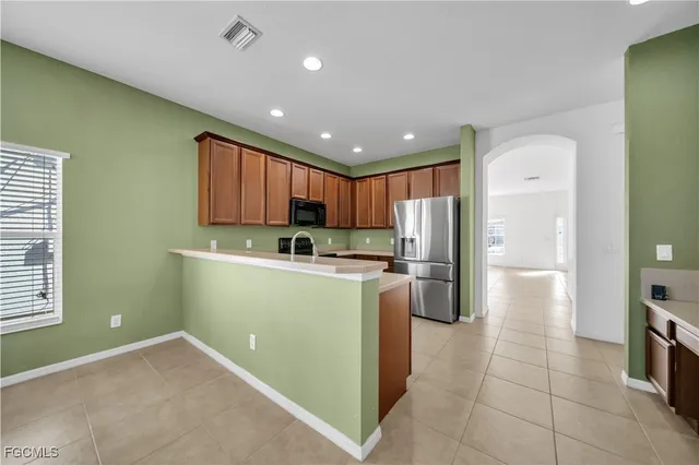 a kitchen with refrigerator and cabinets