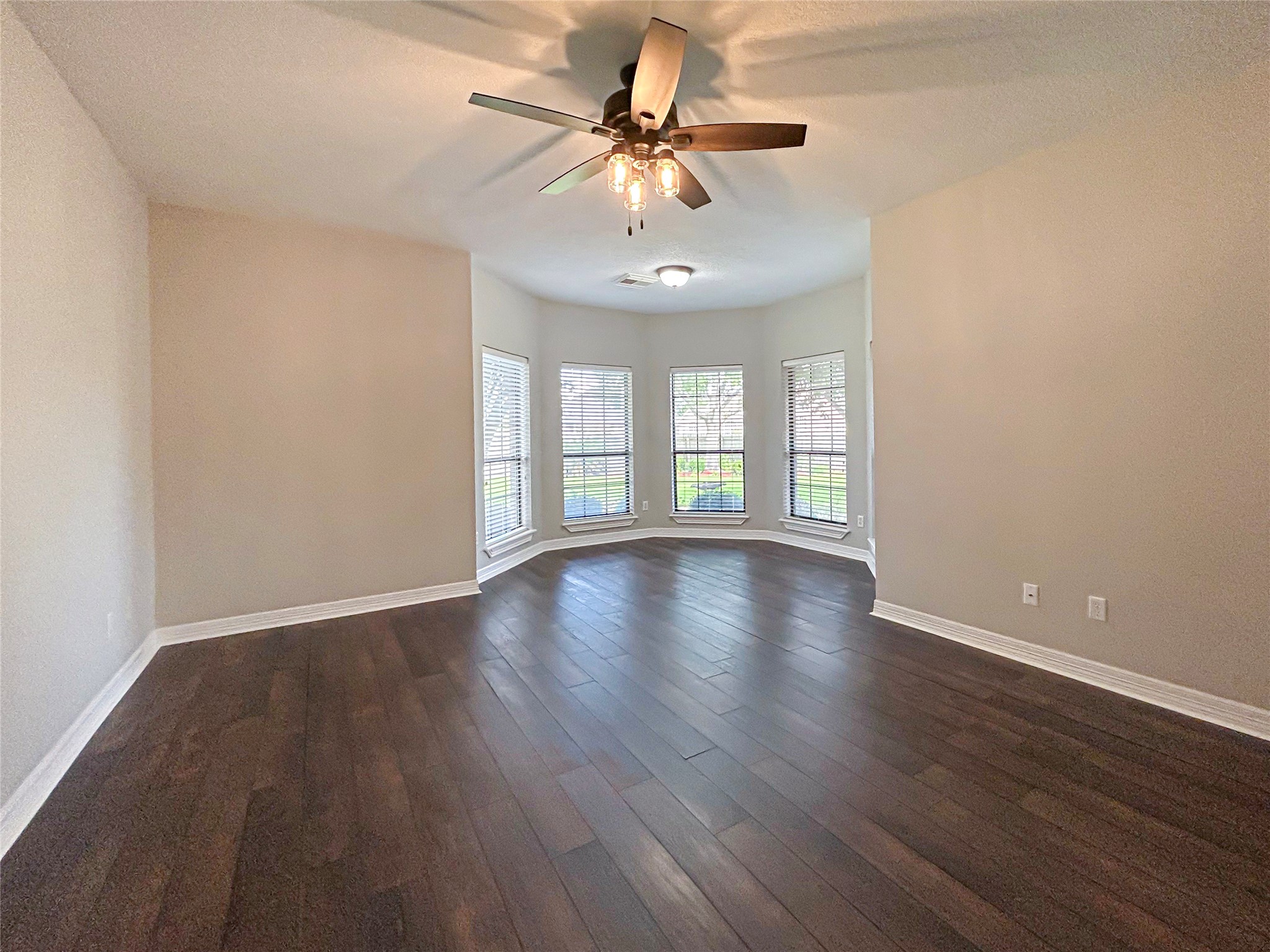 606 Walnut Street Lake Jackson, TX 77566 - Photo 20 of 43 a view of an empty room with window and wooden floor