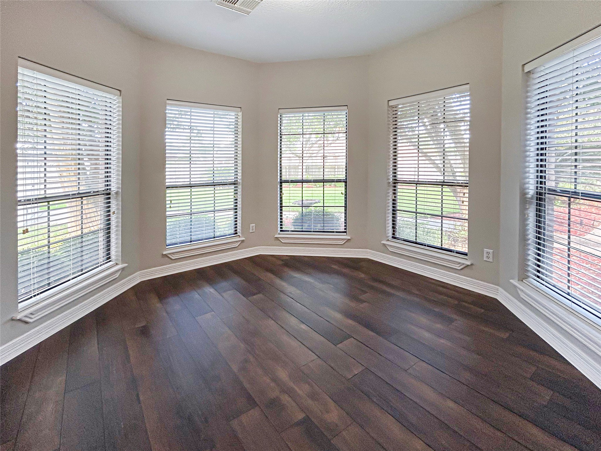 606 Walnut Street Lake Jackson, TX 77566 - Photo 21 of 43 a view of an empty room with wooden floor and a window