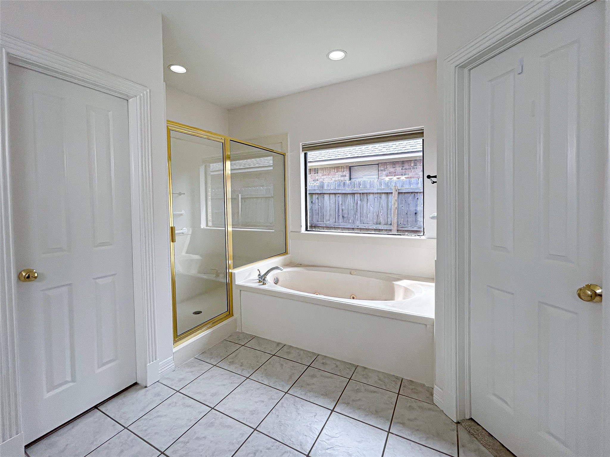 606 Walnut Street Lake Jackson, TX 77566 - Photo 26 of 43 a bathroom with a bathtub and a shower