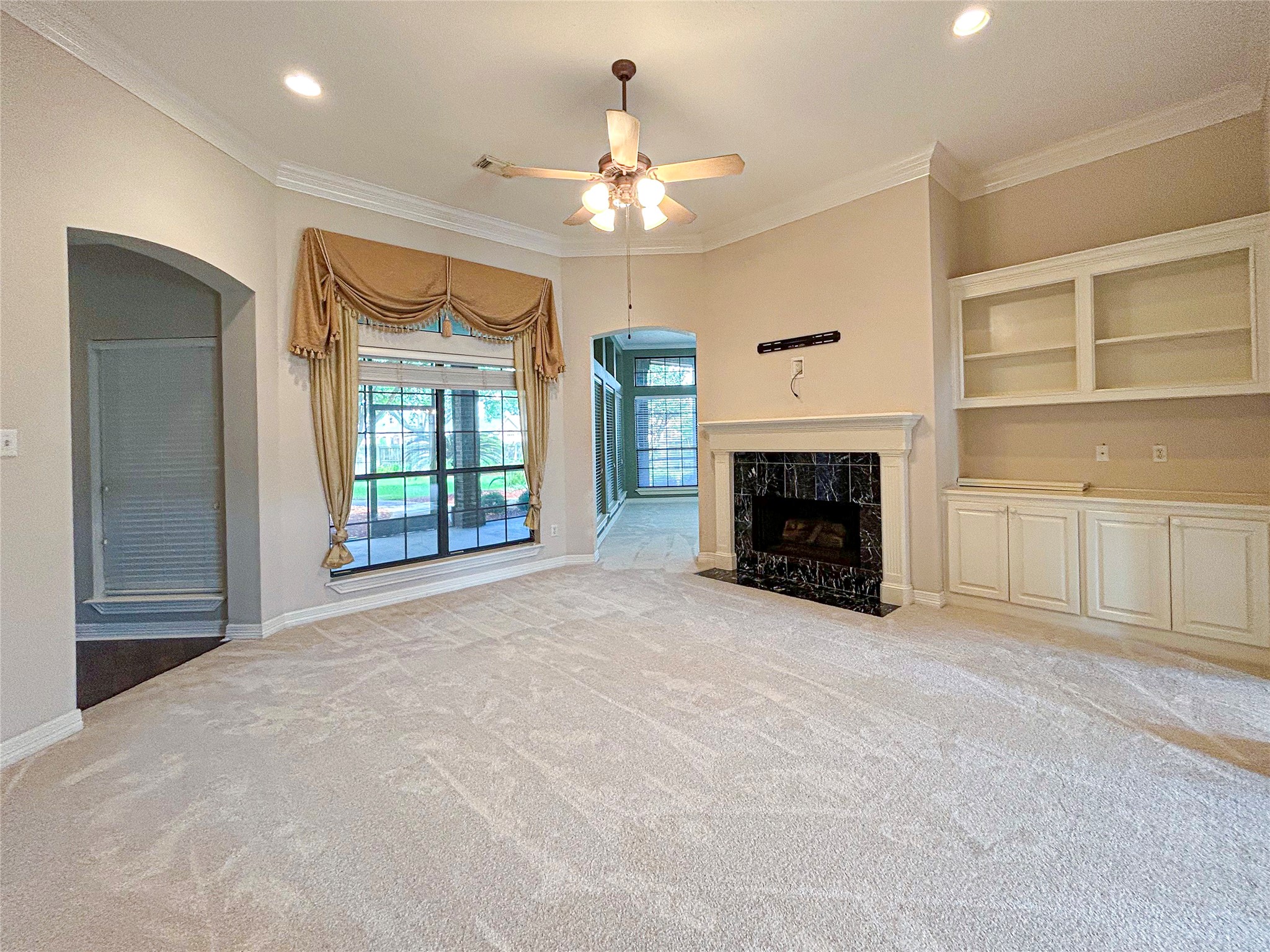 606 Walnut Street Lake Jackson, TX 77566 - Photo 3 of 43 a view of an empty room with a fireplace and a window