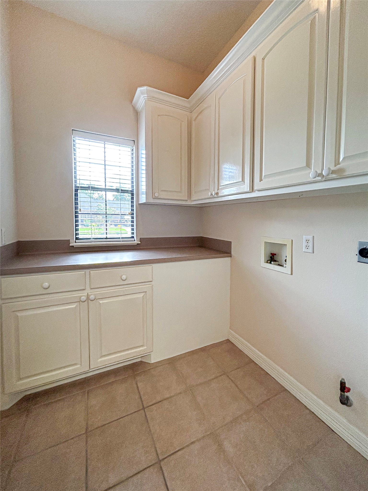 606 Walnut Street Lake Jackson, TX 77566 - Photo 33 of 43 a kitchen with white cabinets and a window