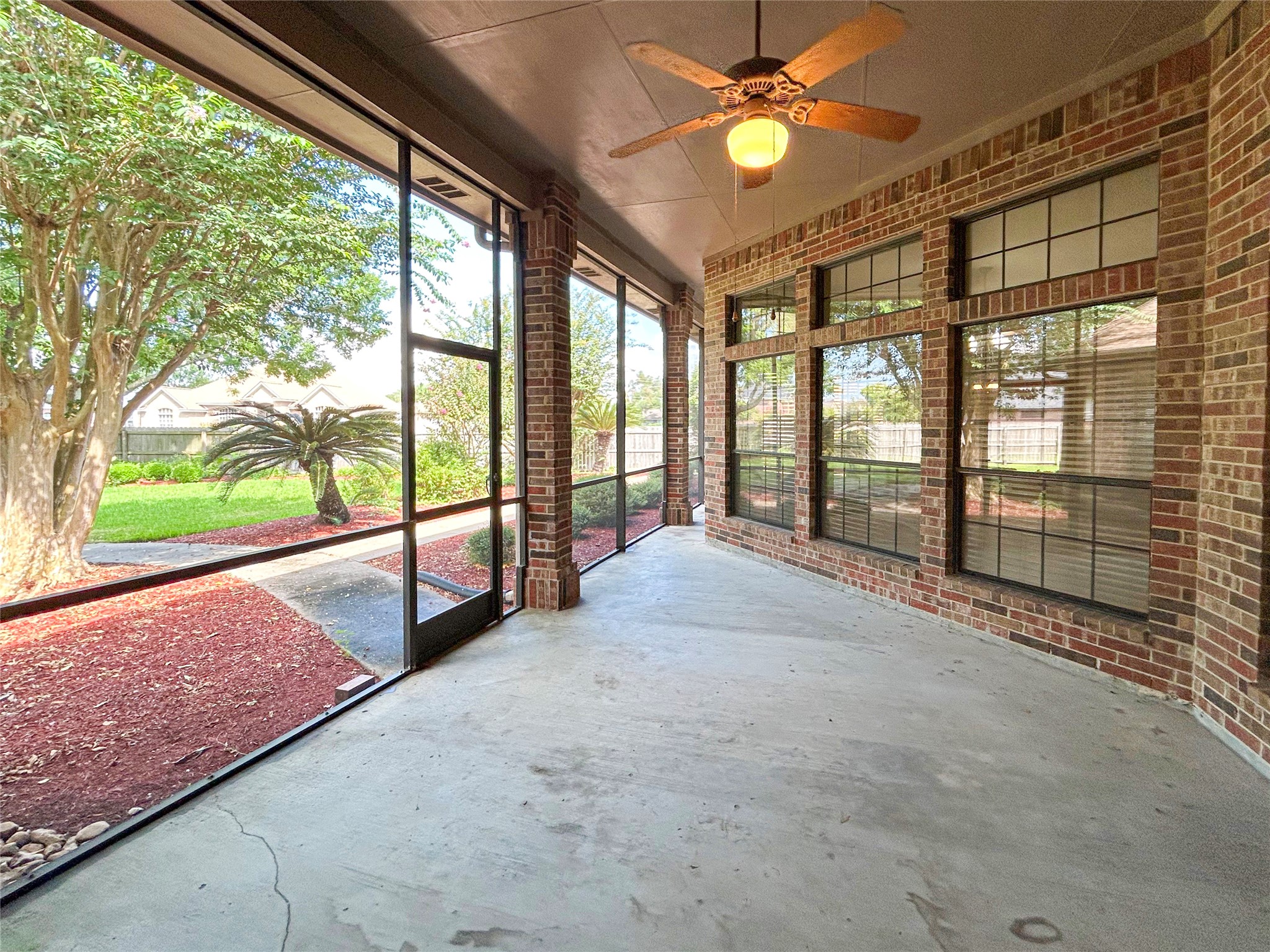 606 Walnut Street Lake Jackson, TX 77566 - Photo 34 of 43 a view of an empty room and window with a ceiling fan