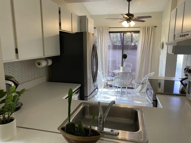 a kitchen with a refrigerator and a stove