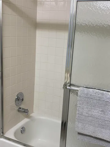 a bathroom with a tub and a shower