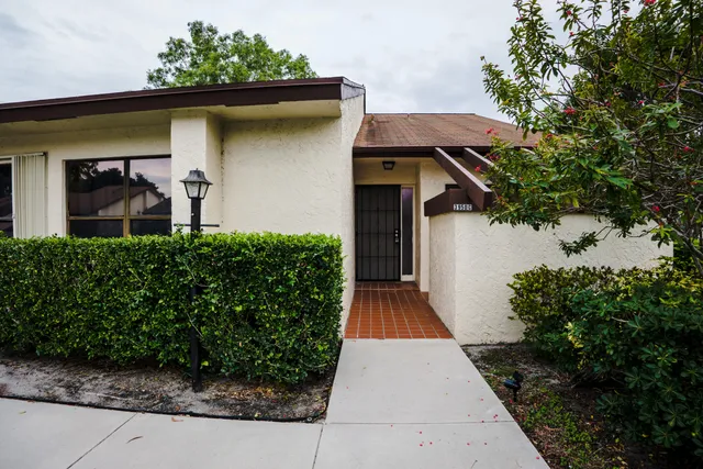 a view of front door and small yard