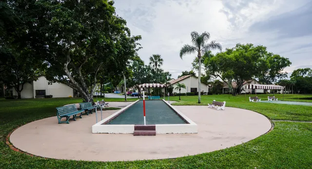 a view of a patio with a table and chairs under an umbrella