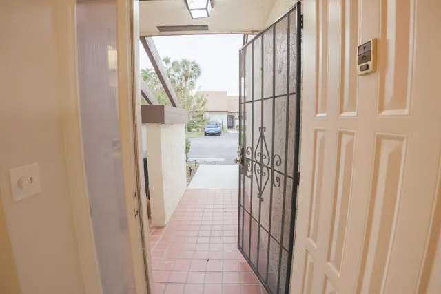 a view of a hallway with wooden floor and entryway