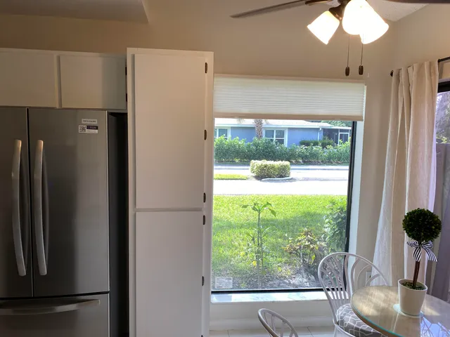 a view of kitchen with furniture and refrigerator