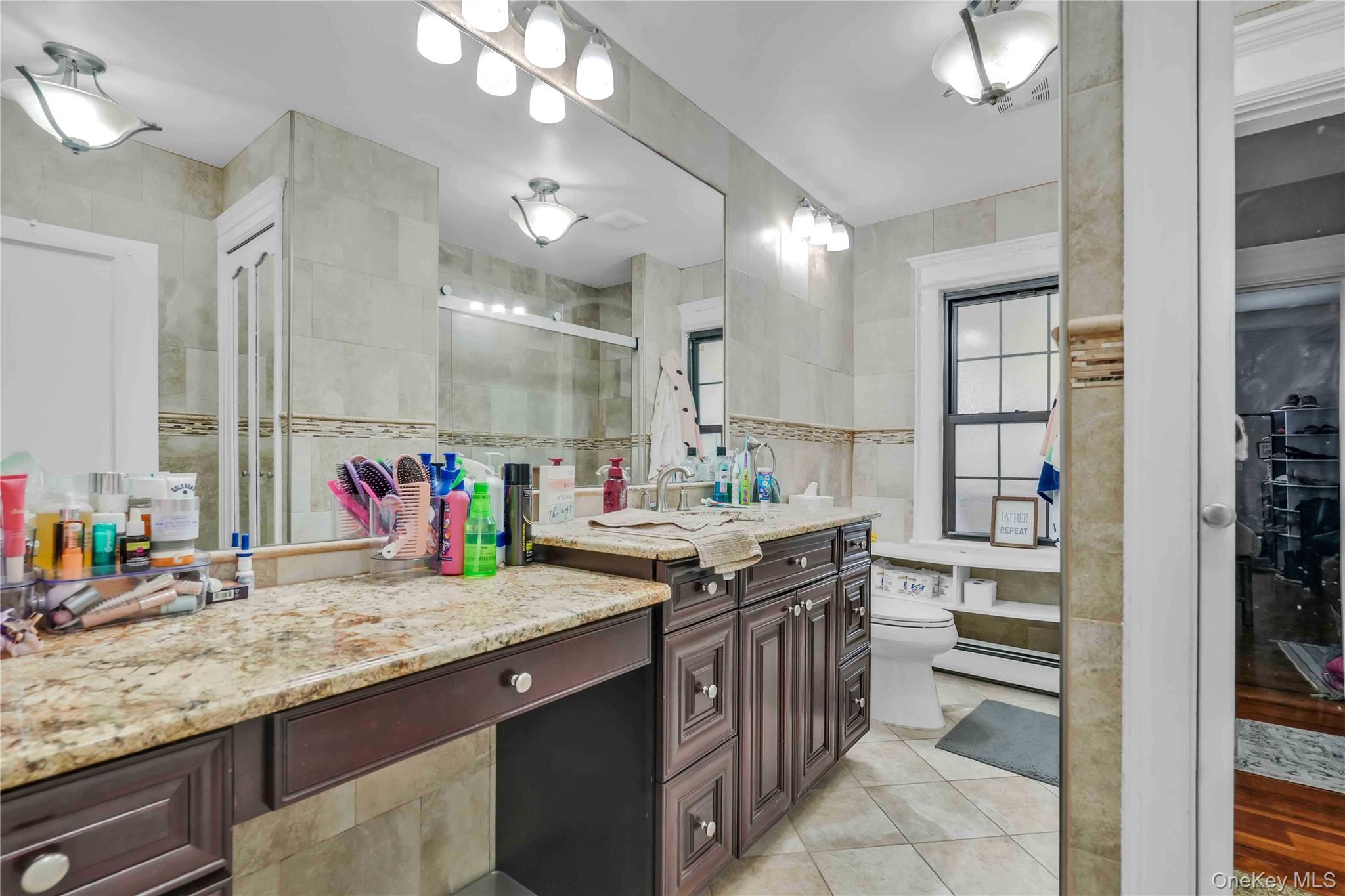 160-08 12th Road Queens, NY 11357 - Photo 10 of 28 a kitchen with granite countertop a sink and cabinets