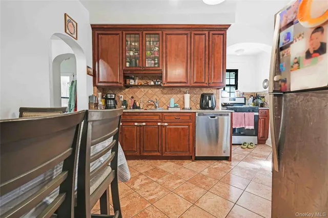 a kitchen with stainless steel appliances granite countertop a refrigerator sink and cabinets