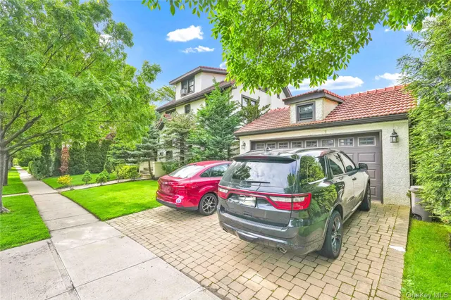 a yellow and red car parked in front of a house