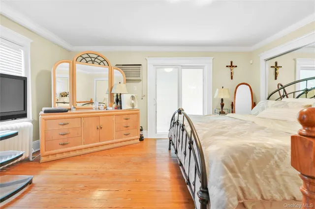 a spacious bedroom with a large bed and dresser