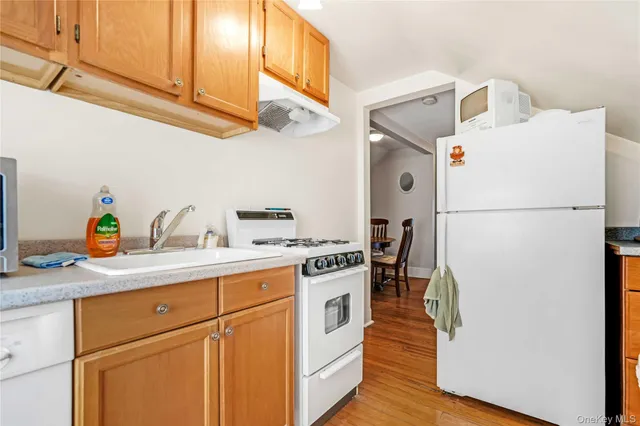 a kitchen with a white cabinets and white appliances