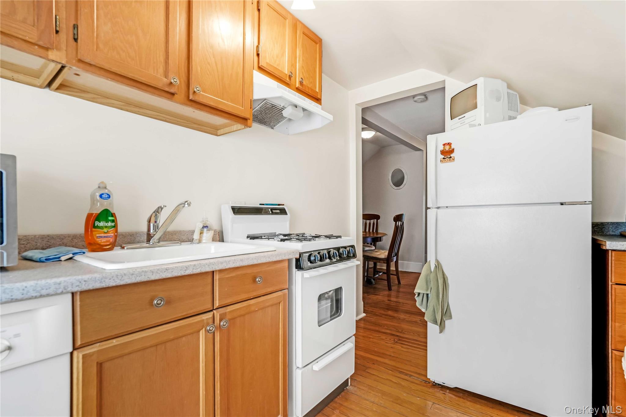 160-08 12th Road Queens, NY 11357 - Photo 24 of 28 a kitchen with a white cabinets and white appliances