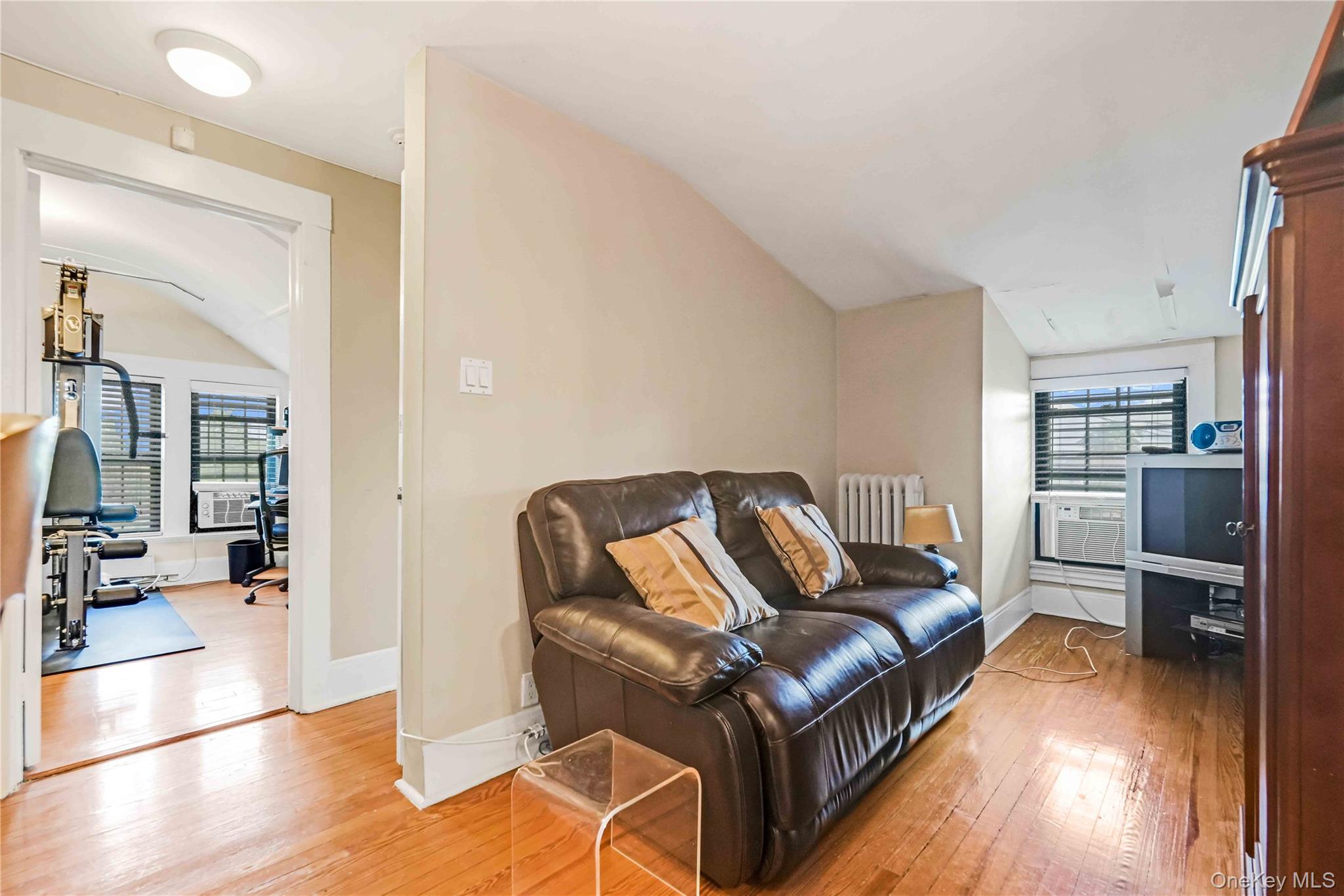 160-08 12th Road Queens, NY 11357 - Photo 26 of 28 a living room with furniture and a wooden floor