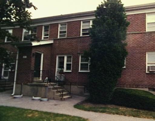 240 Glenbrook Road, Unit 33C Stamford, CT 06906 - Photo 1 of 1 a front view of a house with a yard