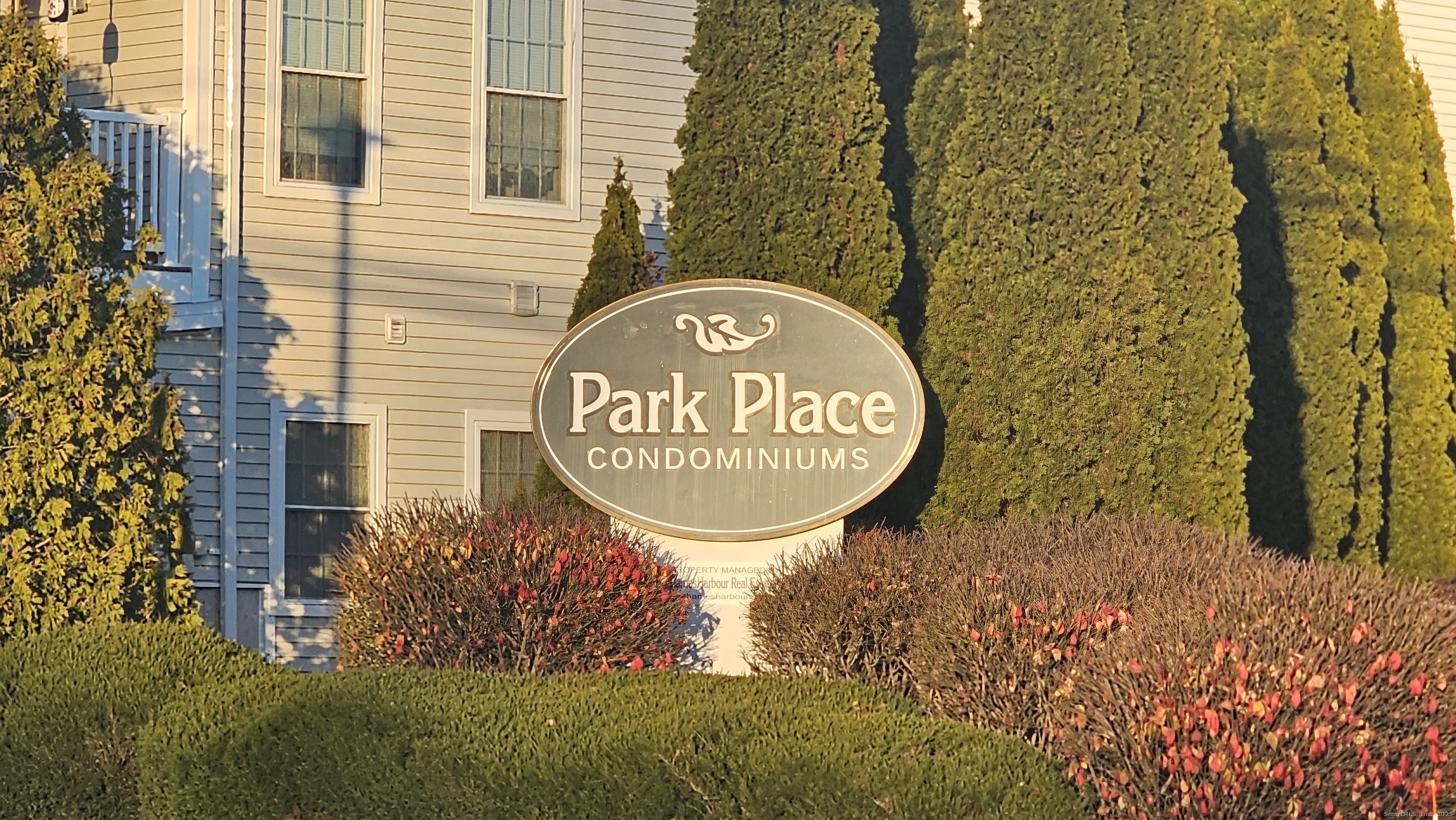 a sign that is next to a brick wall