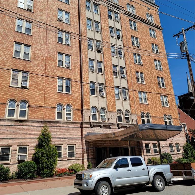 a front view of a building with parking space