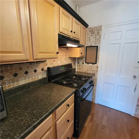a kitchen with stainless steel appliances and refrigerator