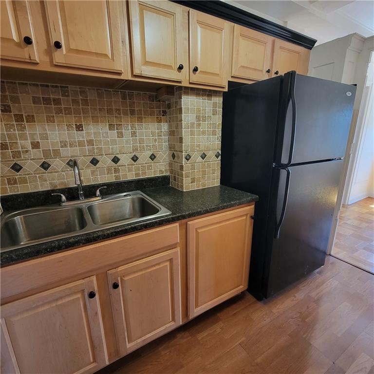 144 North Dithridge Street, Unit 306 Pittsburgh, PA 15213 - Photo 16 of 19 a kitchen with stainless steel appliances granite countertop a refrigerator and a sink