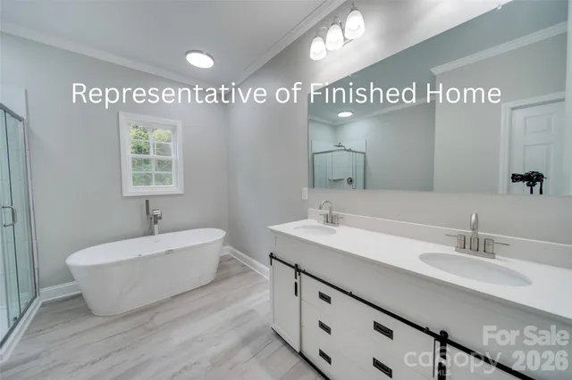 a spacious bathroom with a double vanity sink mirror and a bathtub