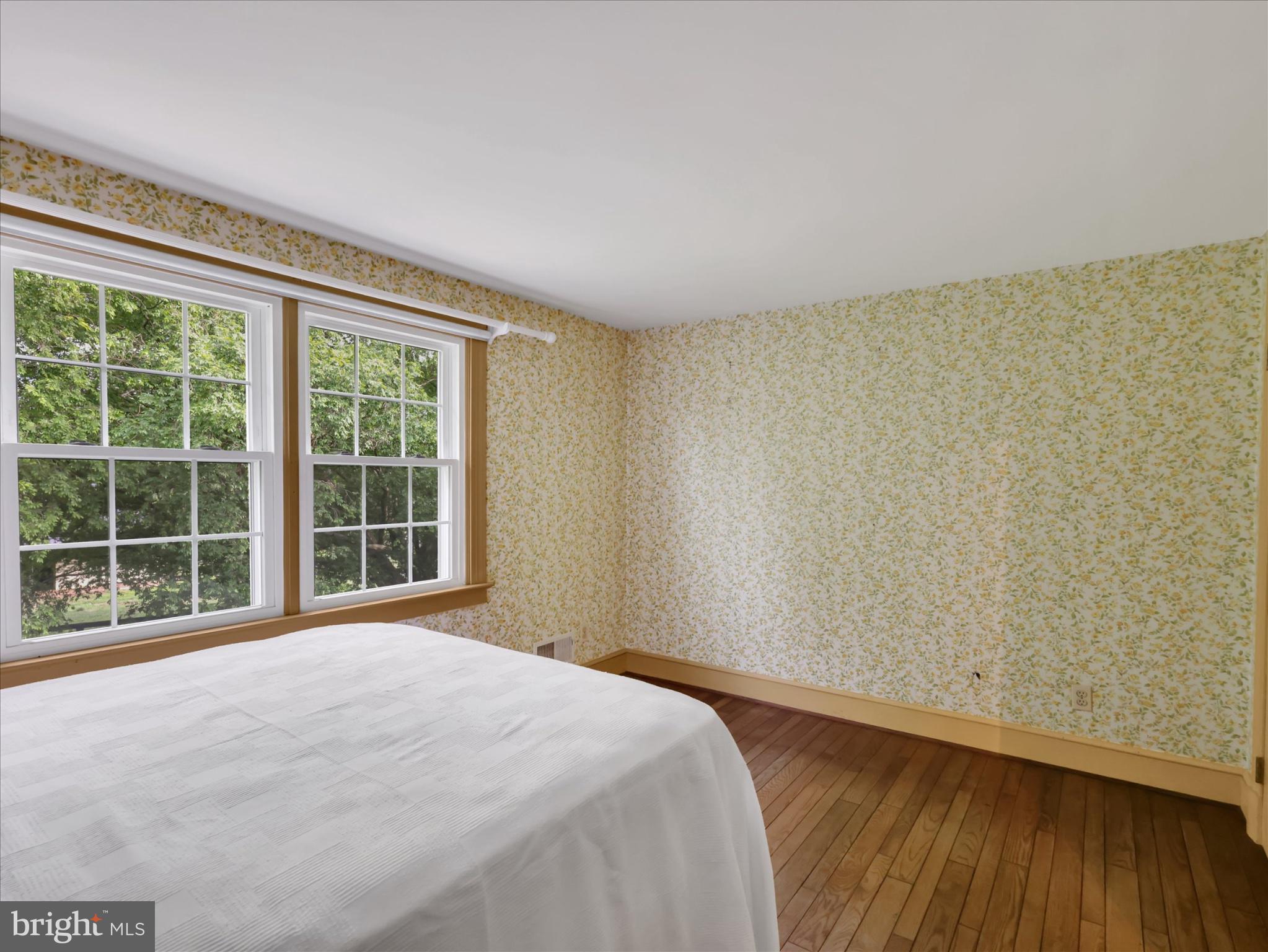 19255 Telegraph Springs Road Purcellville, VA 20132 - Photo 37 of 107 a view of a bedroom with wooden floor and a window