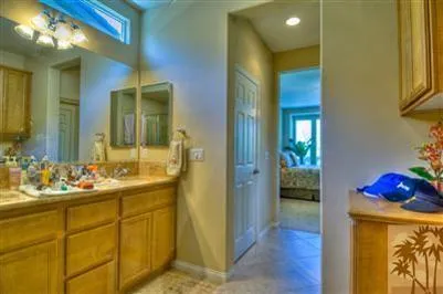 a en suite bathroom with a sink mirror and shower