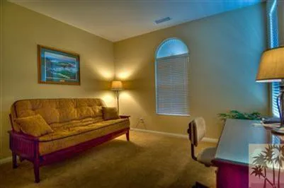 a living room with furniture and a lamp