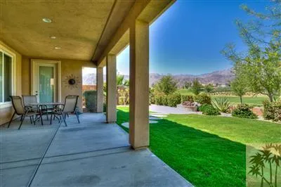 a view of a porch with chairs and backyard