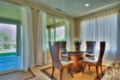 a view of a dining room with furniture and a window