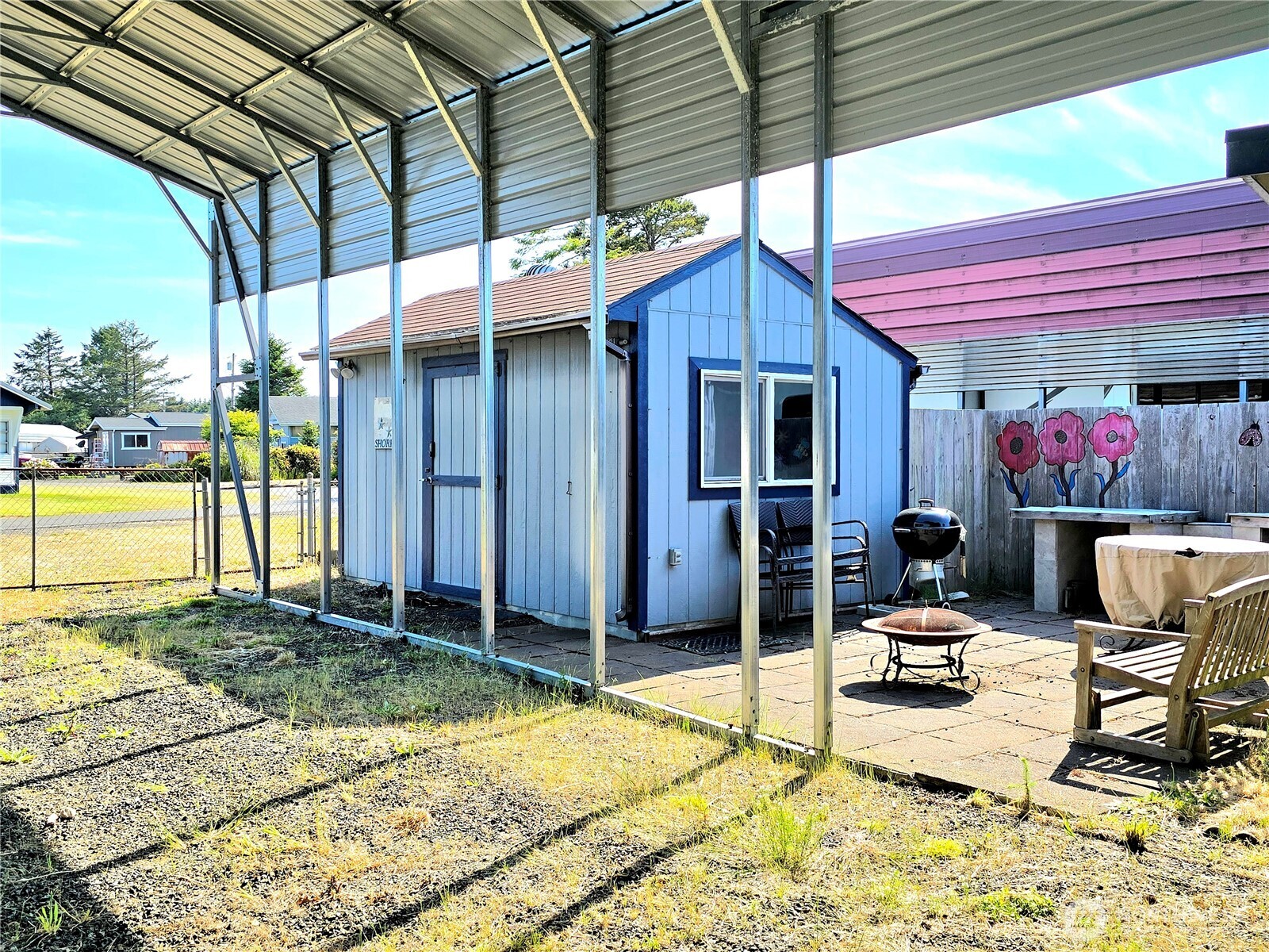 124 Vitoria Loop Ocean Shores, WA 98569 - Photo 7 of 26 a patio with a table and chairs and potted plants