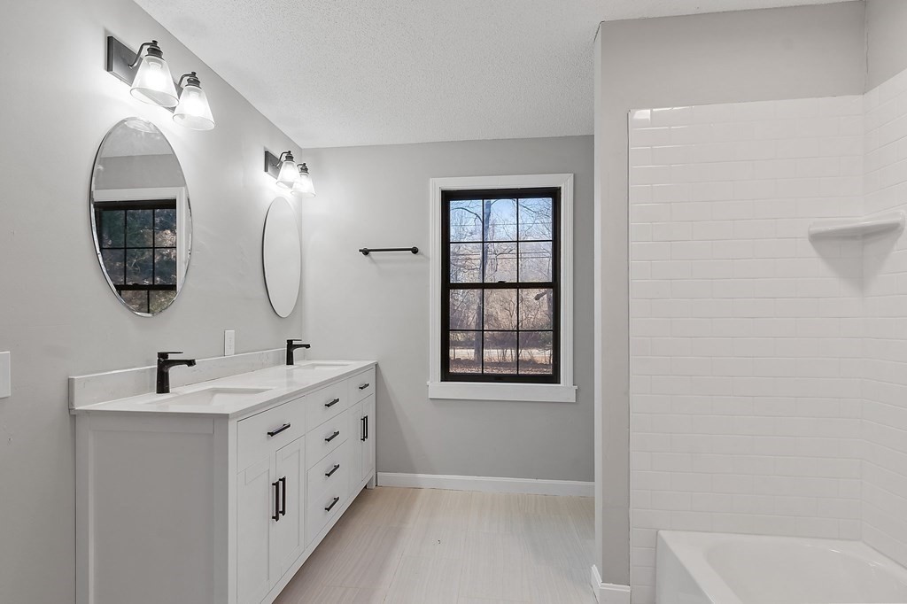 43 Hadley Road Merrimac, MA 01860 - Photo 14 of 19 a bathroom with a double vanity sink mirror and bathtub