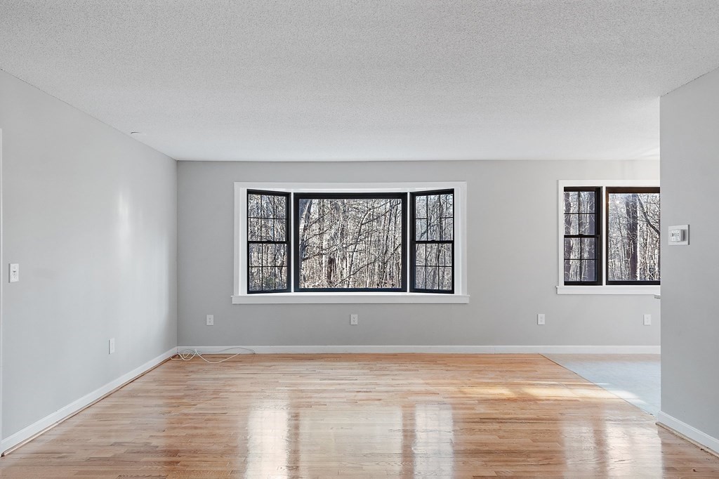 43 Hadley Road Merrimac, MA 01860 - Photo 6 of 19 a view of an empty room with wooden floor and a window