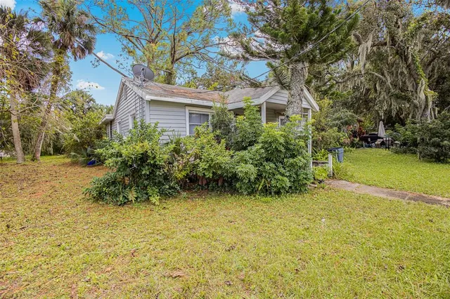 a yellow house with trees in front of it