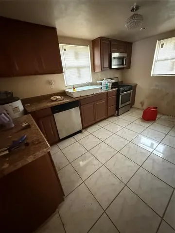 a kitchen with stainless steel appliances granite countertop a sink and a stove