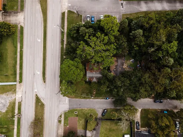 an aerial view of a house with a yard