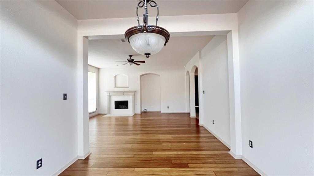 6510 Valley Forge Drive Rowlett, TX 75089 - Photo 5 of 14 a view of a livingroom with wooden floor and a chandelier