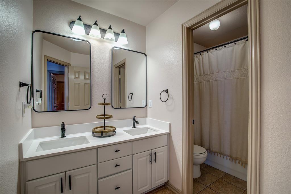 6510 Valley Forge Drive Rowlett, TX 75089 - Photo 10 of 14 a bathroom with a double vanity sink and a mirror